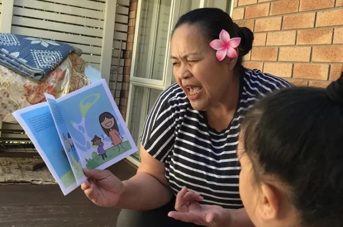 An educator reads a picture book expressively to a child.
