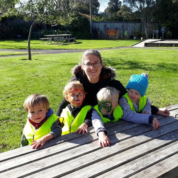 Children in hi-vis vests on an outing with Rachelle, home-based educator in Waitara