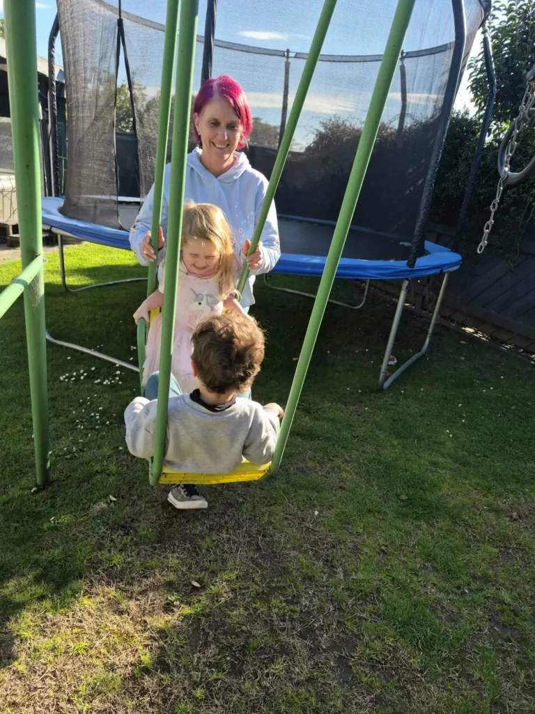 A back garden with a swing and trampoline at Becks' home in Napier